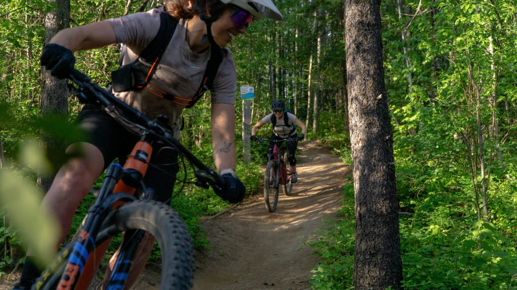 Biking with a friend in Fernie, BC. Lush green forrest.