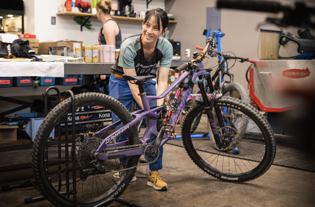 mountain biker with bike in a bike shop.